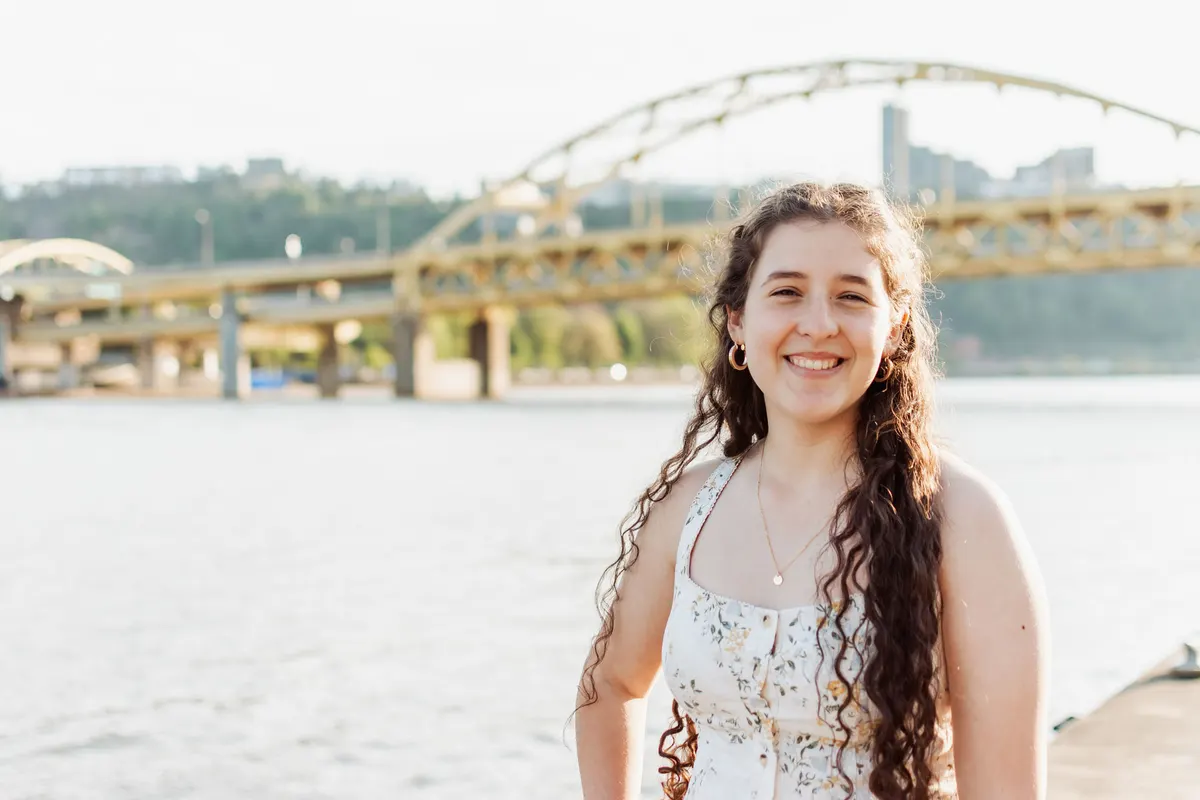 Senior on Pittsburgh’s North Shore with the yellow bridges behind her