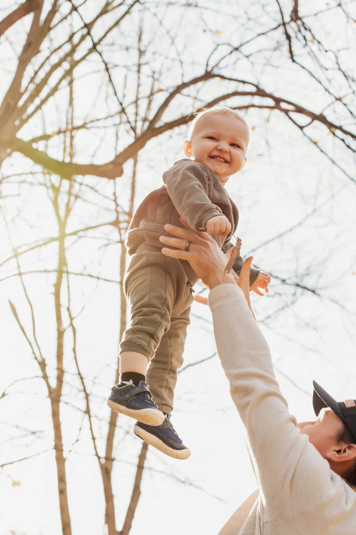 Dad lifting his laughing baby into the air