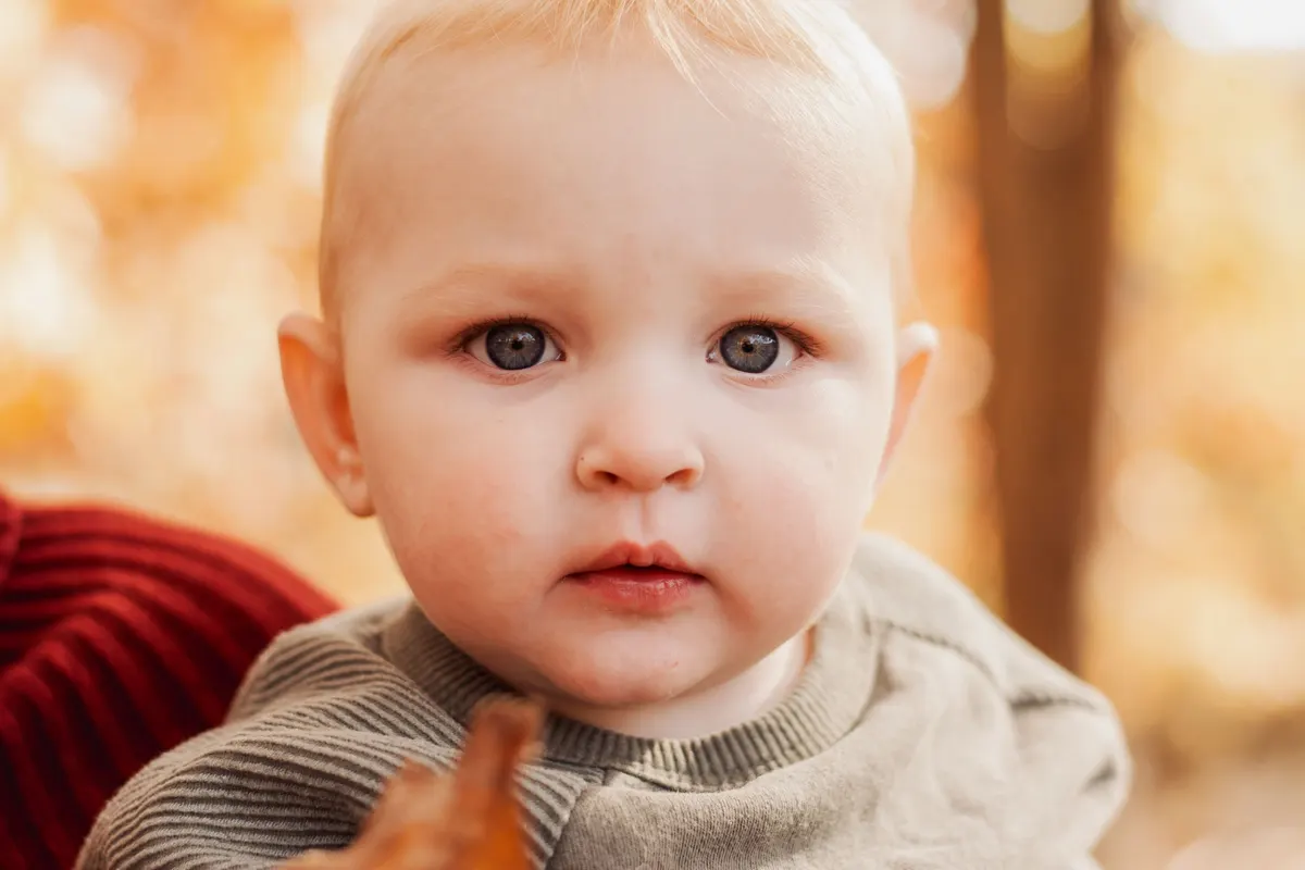 Close-up portrait of a baby in warm fall color at South Park