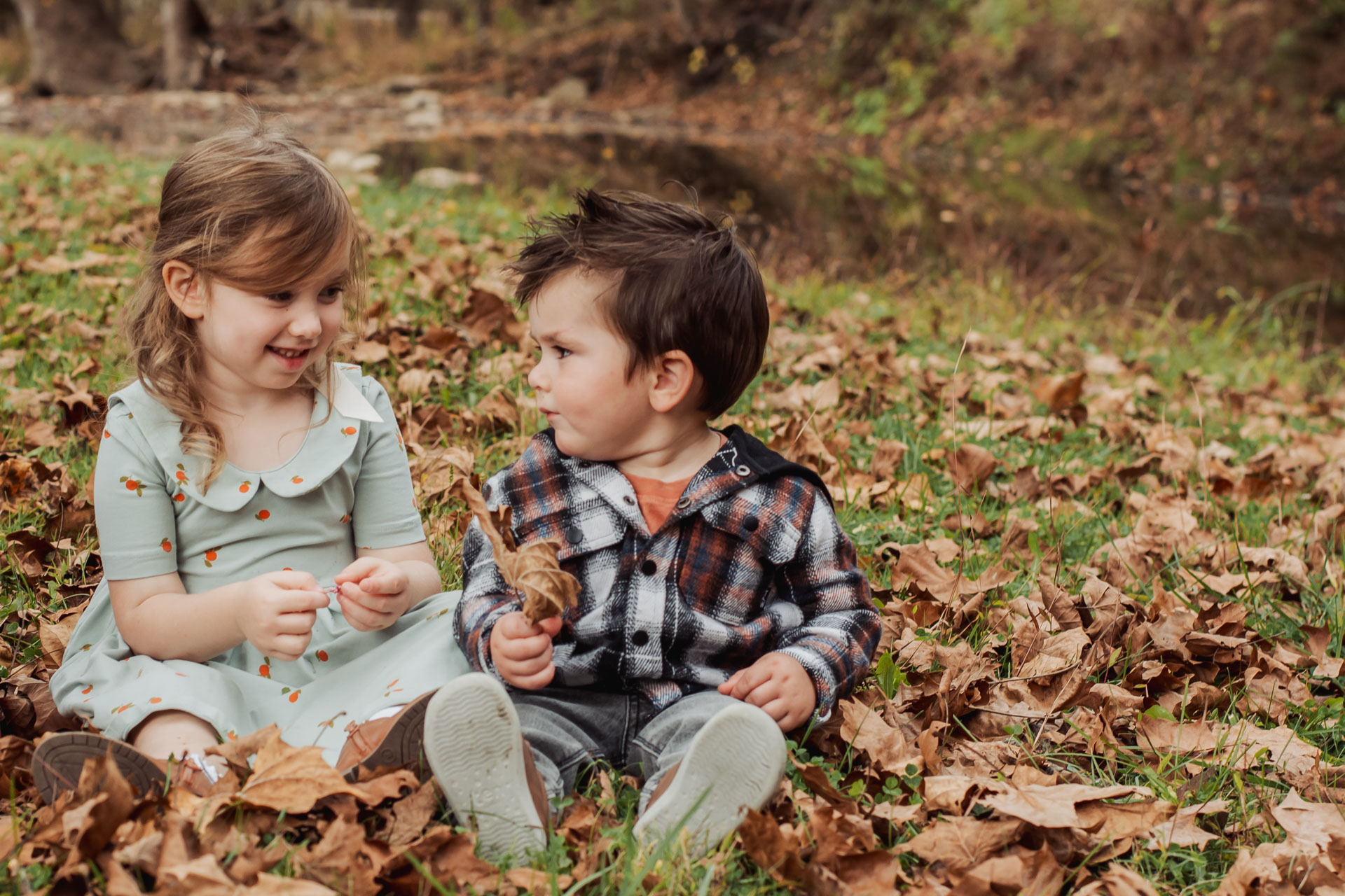 Family playing together in a meadow at Boyce Mayview Park in Upper St. Clair, PA